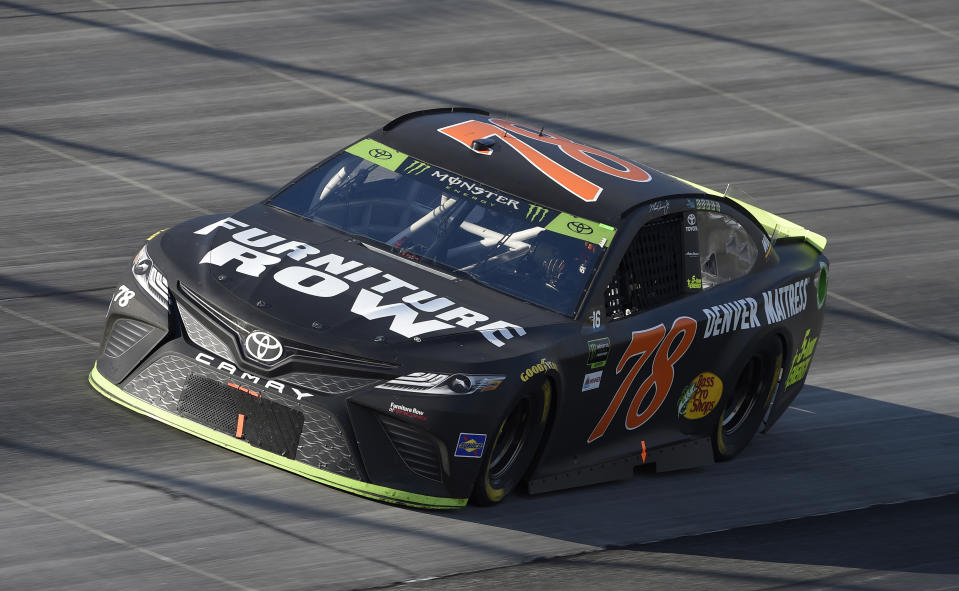 FILE - In this Oct. 1, 2017, file photo, Martin Truex Jr. competes during the NASCAR Cup Series auto race, at Dover International Speedway in Dover, Del. Furniture Row Racing will cease operations at the end of this season, shutting its doors one year after Martin Truex Jr. won NASCAR’s championship driving for the maverick race team. Furniture Row is an anomaly in NASCAR in that it is a single-car team based in Denver, Colorado, far removed from the North Carolina hub. Team owner Barney Visser was a racing enthusiast with a vision when he launched the team in 2005 determined to do it his own way. But a lack of sponsorship for next season led Visser to make the “painful decision” to close the team. (AP Photo/Nick Wass, File)