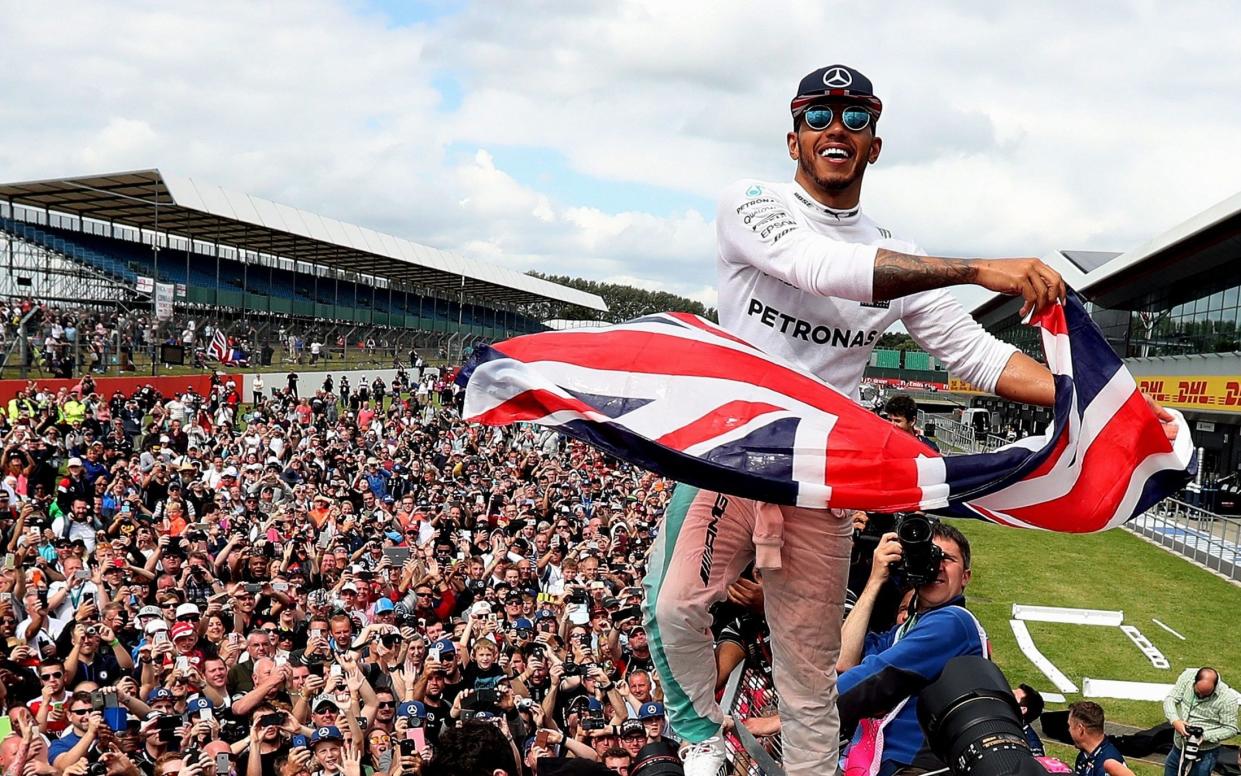 Lewis Hamilton celebrates his victory with the crowd after winning the 2016 British Grand Prix at Silverstone Circuit, Towcester -  PA