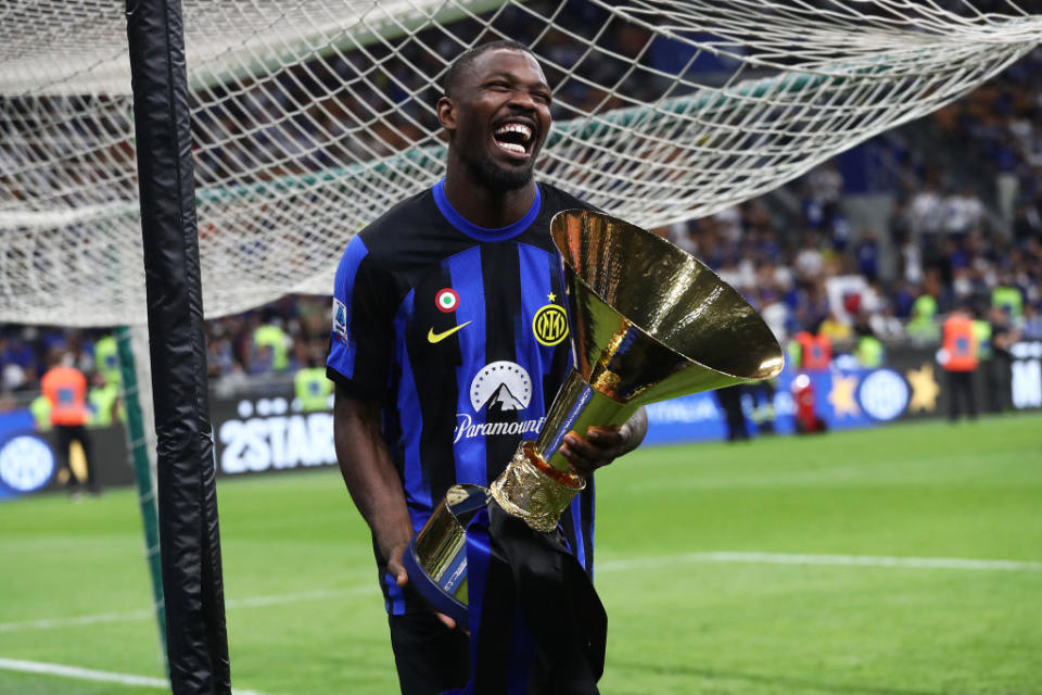 MILAN, ITALY - MAY 19: Marcus Thuram of FC Internazionale celebrates with the Serie A TIM Scudetto title trophy at full-time following the team's draw in the Serie A TIM match between FC Internazionale and SS Lazio at Stadio Giuseppe Meazza on May 19, 2024 in Milan, Italy. (Photo by Marco Luzzani/Getty Images)