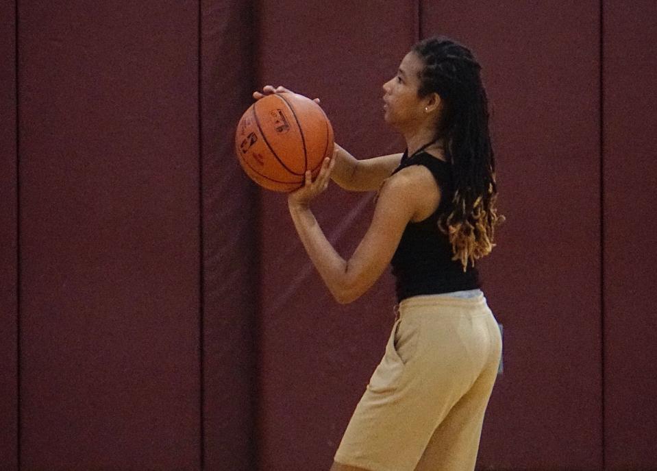 A girl gets ready to shoot a baksetball at the West High fundraiser.