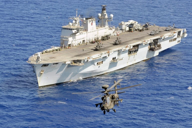 An Army Air Corps Apache helicopter takes off from British Royal Navy amphibious assault ship HMS Ocean during Operation Ellamy, in the Mediterranean Sea