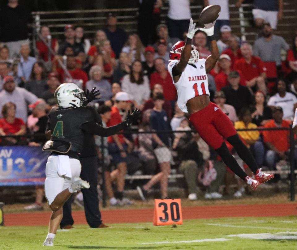 Savannah Christian's Kenry Wall elevates to haul in a Blaise Thomas pass in front of Savannah Country Day's Carson Cook during the Friday, September 15, 2023 matchup at Savannah Country Day.