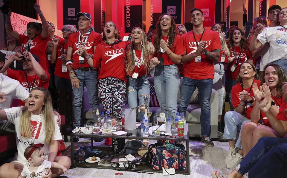 Caeleb Dressel's family reacts Friday, July 30, 2021, in Orlando, Fla., as he wins the men's swimming 100-meter butterfly at the Tokyo Olympics. (Stephen M. Dowell/Orlando Sentinel via AP)