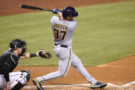Milwaukee Brewers' Adrian Houser (37) hits a solo home run during the fourth inning of a baseball game against the Miami Marlins, Saturday, May 8, 2021, in Miami. At left is Miami Marlins catcher Chad Wallach. (AP Photo/Lynne Sladky)