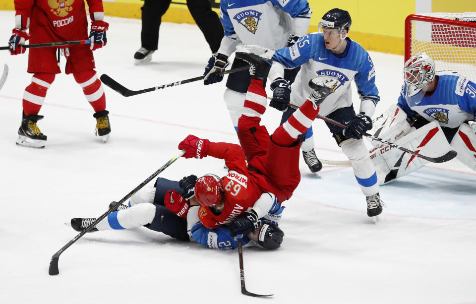 Russia's Yevgeni Dadonov, right, collides with Finland's Juhani Tyrvainen, left, during the Ice Hockey World Championships semifinal match between Russia and Finland at the Ondrej Nepela Arena in Bratislava, Slovakia, Saturday, May 25, 2019. (AP Photo/Petr David Josek)