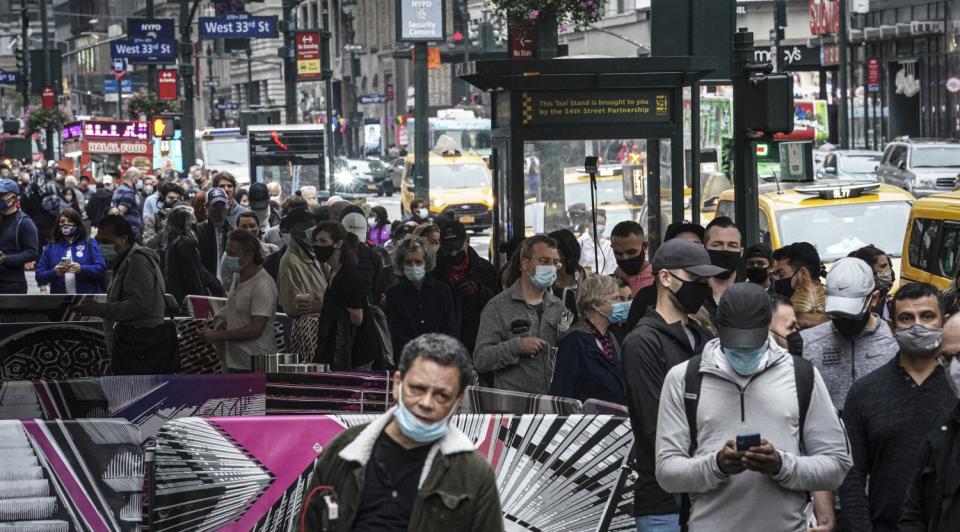 Voters in masks crowd a sidewalk outside Madison Square Garden.