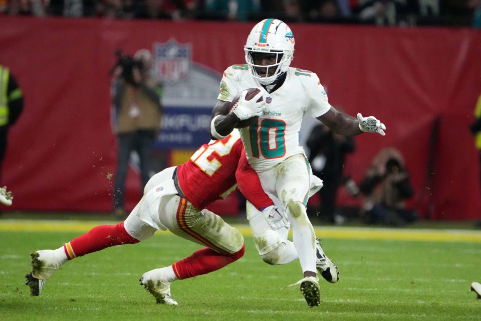 Nov 5, 2023; Frankfurt, Germany; Miami Dolphins wide receiver Tyreek Hill (10) carries the ball against Kansas City Chiefs linebacker Nick Bolton (32) in the second half during an NFL International Series game at Deutsche Bank Park. Mandatory Credit: Kirby Lee-USA TODAY Sports