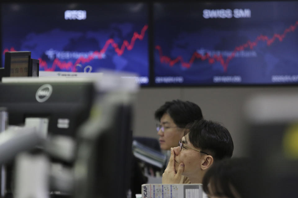 A currency trader watches monitors at the foreign exchange dealing room of the KEB Hana Bank headquarters in Seoul, South Korea, Wednesday, Jan. 8, 2020. Oil prices rose and Asian stock markets fell Wednesday after Iran fired missiles at U.S. bases in Iraq in retaliation for the killing of an Iranian general. (AP Photo/Ahn Young-joon)