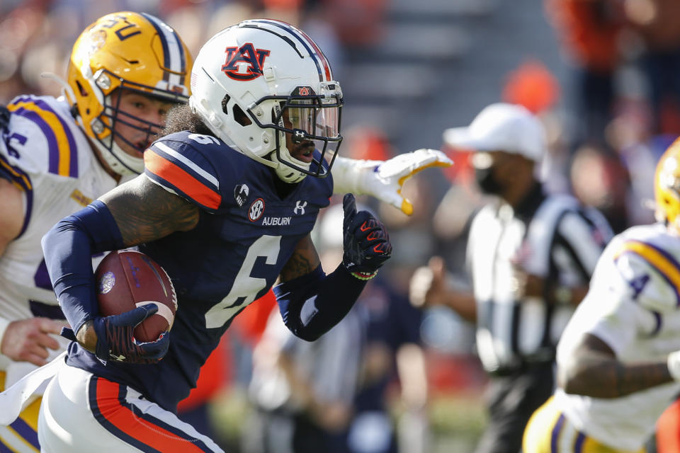 Auburn defensive back Christian Tutt (6) returns a fumble by LSU quarterback TJ Finley for a touchdown during the second quarter of an NCAA college football game Saturday, Oct. 31, 2020, in Auburn, Ala. (AP Photo/Butch Dill)