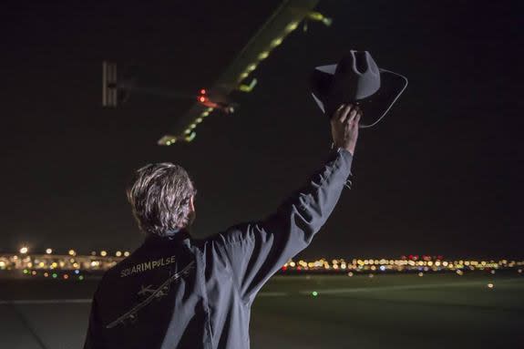Solar Impulse co-founder Andre? Borschberg waves his cowboy hat as the solar-powered aircraft departs Dallas on June 3, 2013.