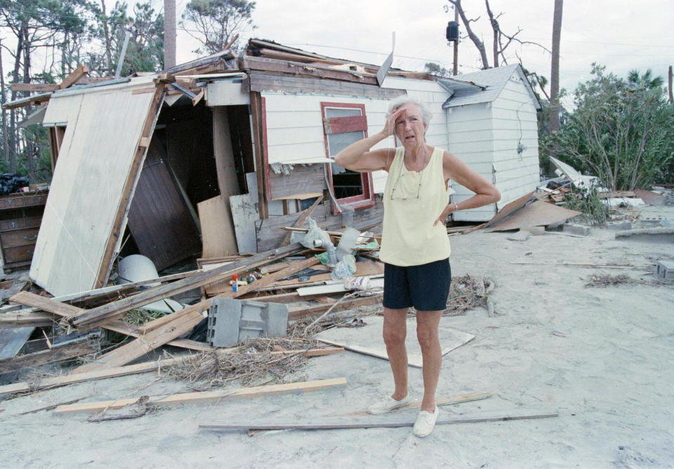 FILE- In this Sept. 23, 1989 file photo, Lou de Liesseline pauses in despair after looking at the damage to her home on Folly Beach. The water surge caused by Hurricane Hugo moved the house off its foundations and back 100 feet. Hurricane Hugo might have been the first modern U.S. storm ushering in an era of live TV coverage and large scale coastal evacuations. (AP Photo/J. Scott Applewhite, File)