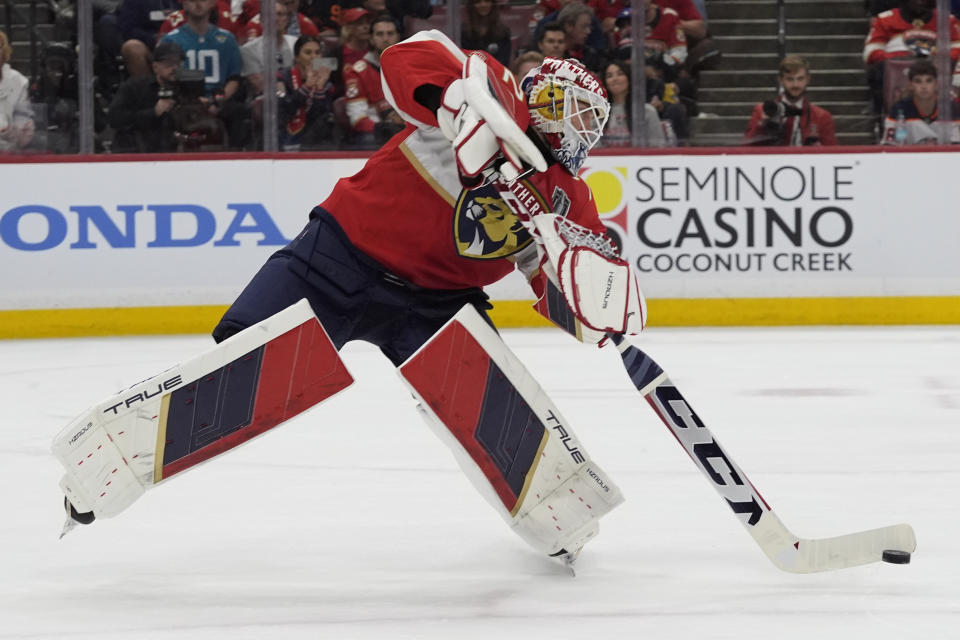 Florida Panthers goaltender Sergei Bobrovsky passes the puck during the first period of Game 1 of the NHL hockey Stanley Cup Finals against the Edmonton Oilers, Saturday, June 8, 2024, in Sunrise, Fla. (AP Photo/Wilfredo Lee)
