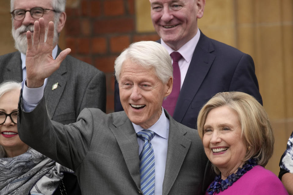 Former US President Bill Clinton and former US Secretary of State Hillary Clinton wave to reporters on the first day of a three-day international conference at Queen's University Belfast to mark the 25th anniversary of the Good Friday Agreement, in Belfast, Northern Ireland, Monday, April 17, 2023. Former U.S. President Bill Clinton and past leaders of the U.K. and Ireland are gathering in Belfast on Monday, 25 years after their charm, clout and determination helped Northern Ireland strike a historic peace accord. (AP Photo/Christophe Ena)