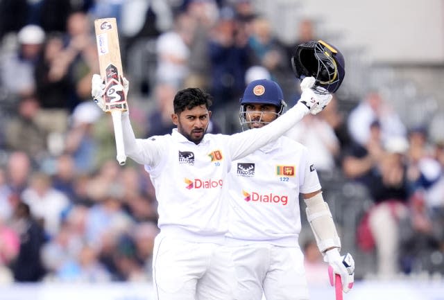 Sri Lanka’s Kamindu Mendis celebrates his hundred by raising his bat and helmet