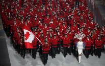 Canada's flag-bearer Hayley Wickenheiser leads her country's contingent during the opening ceremony of the 2014 Sochi Winter Olympics, February 7, 2014. REUTERS/Lucy Nicholson (RUSSIA - Tags: OLYMPICS SPORT)