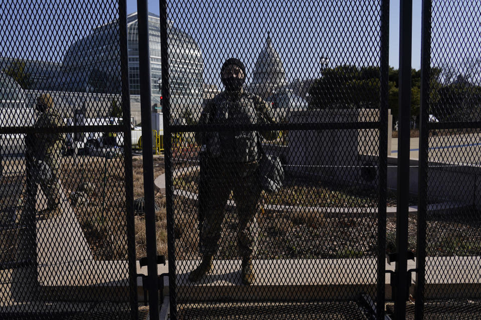 National Guard stand guard at a perimeter fence at the Capitol in Washington, Thursday, March 4, 2021. (AP Photo/Carolyn Kaster)