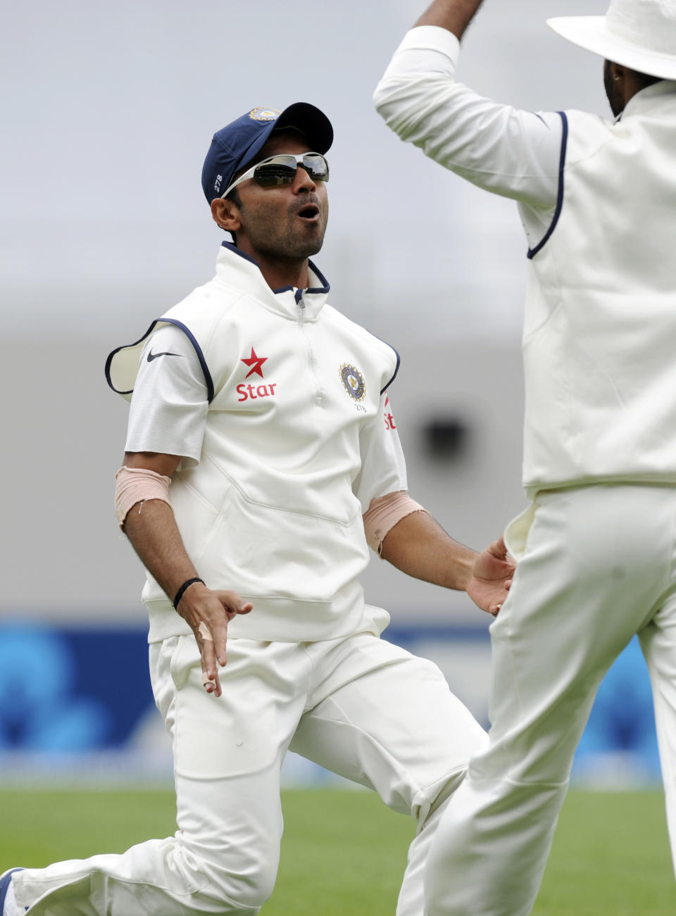 India’s Ajinkya Rahane, left, celebrates taking the catch to dismiss New Zealand’s Hamish Rutherford for 6 in the first cricket test at Eden Park in Auckland, New Zealand, Thursday, Feb. 6, 2014. (AP Photo/SNPA, Ross Setford) NEW ZEALAND OUT