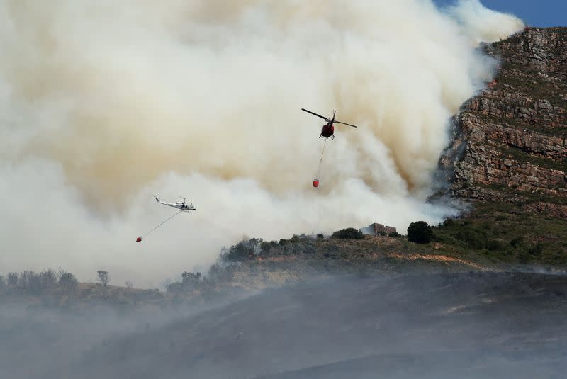 Helicopters battle a bushfire that broke out on the slopes of Table Mountain in Cape Town