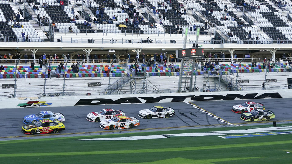 Brett Moffitt (02) and Austin Cindric (22) lead the field to start the NASCAR Xfinity Series road course auto race at Daytona International Speedway, Saturday, Feb. 20, 2021, in Daytona Beach, Fla. (AP Photo/John Raoux)