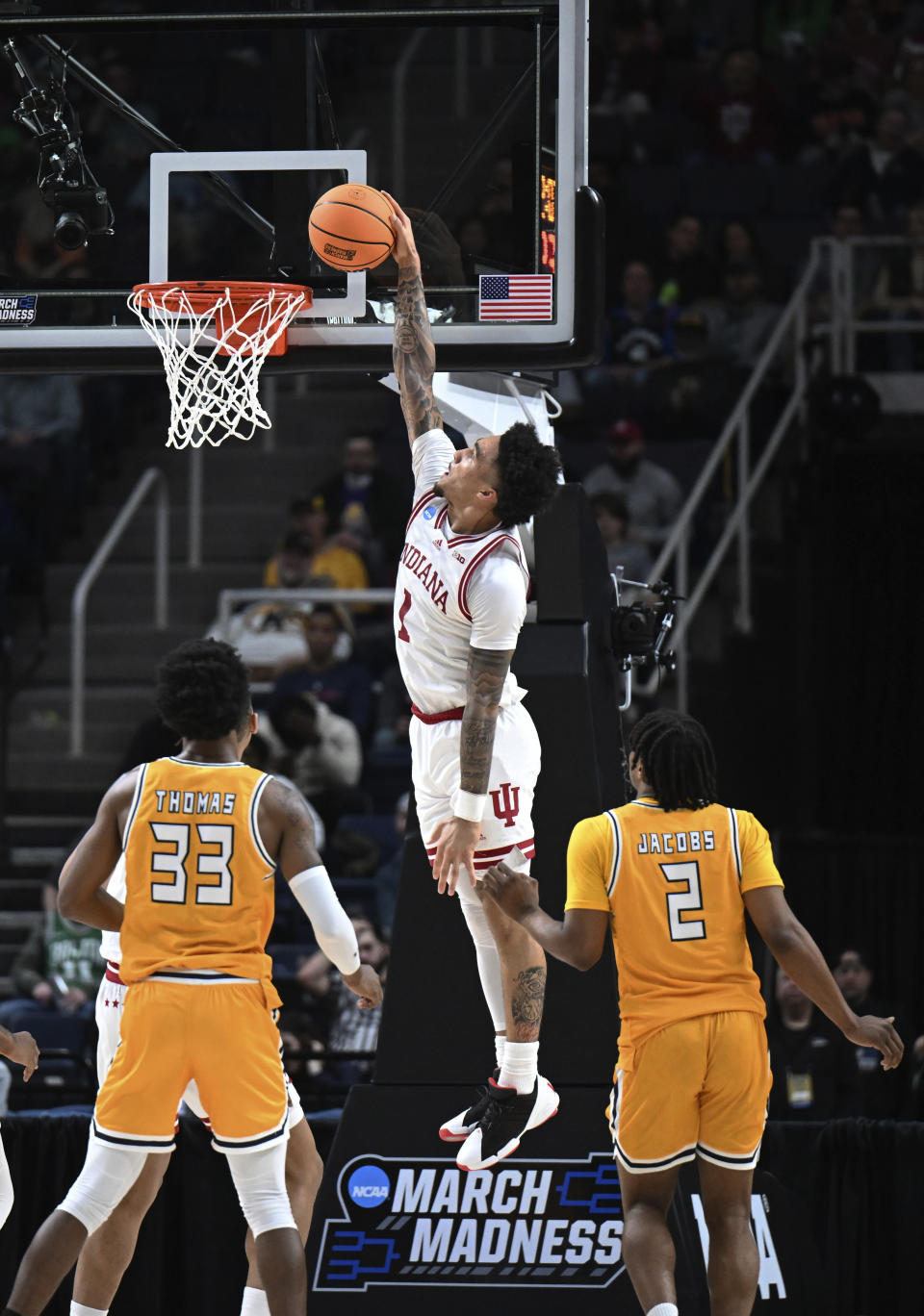 Indiana guard Jalen Hood-Schifino scores against Kent State forward Miryne Thomas (33) and guard Malique Jacobs (2) during the first half of a first-round college basketball game in the NCAA Tournament Friday, March 17, 2023, in Albany, N.Y. (AP Photo/Hans Pennink)