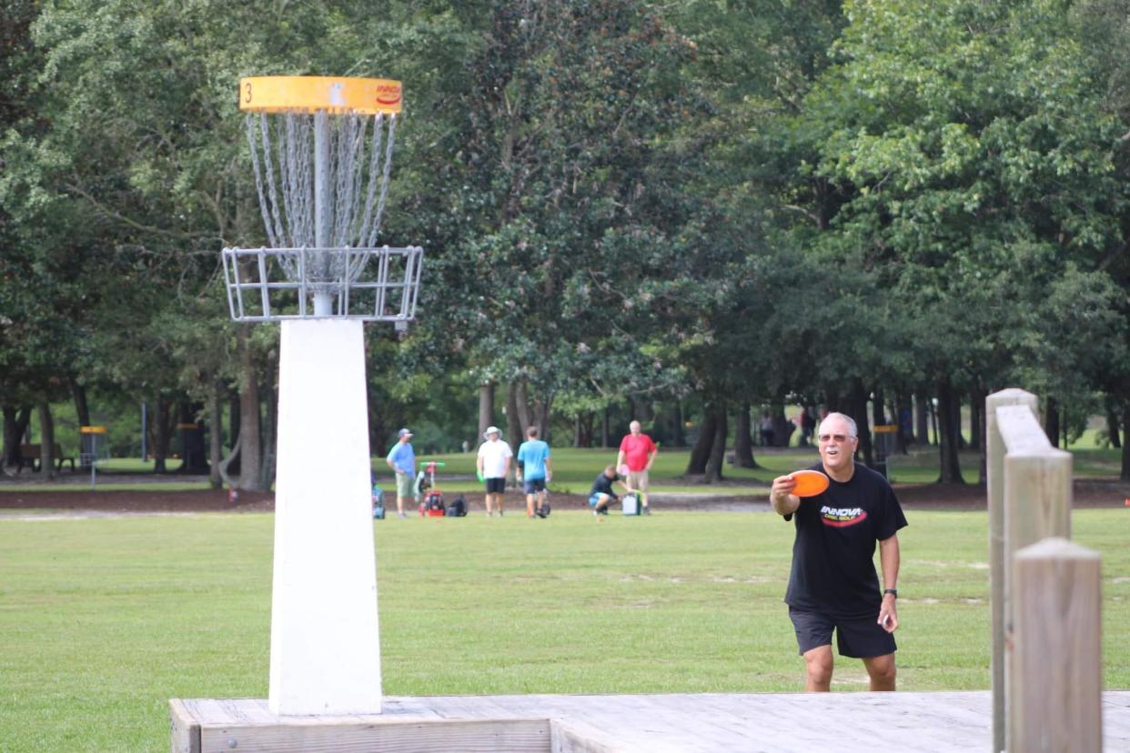 Bill Stackhouse lines up for a throw during a game of disc golf at Founders Park in Leland in September.