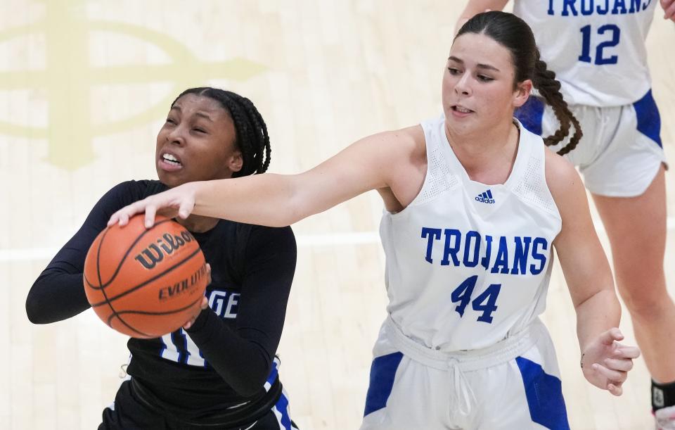 Bishop Chatard Trojans center Anna Caskey (44) blocks Heritage Christian forward Trinity Taylor (11) on Thursday, Jan. 11, 2024, during the City Tournament semifinals at Cathedral High School in Indianapolis. The Bishop Chatard Trojans defeated Heritage Christian, 56-45.