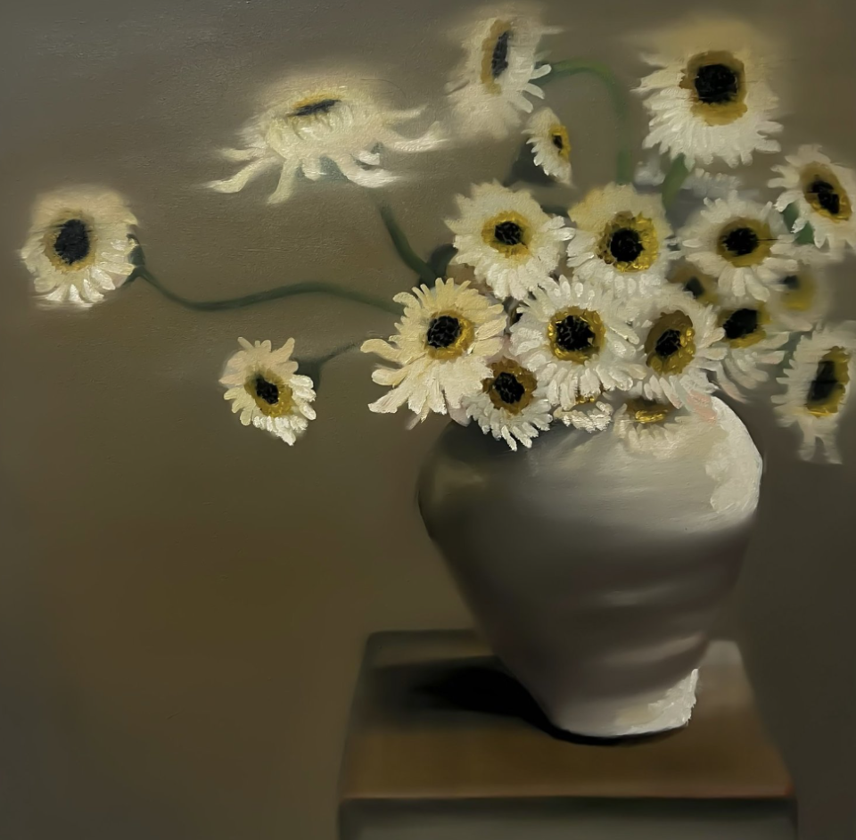 a vase with white daisies