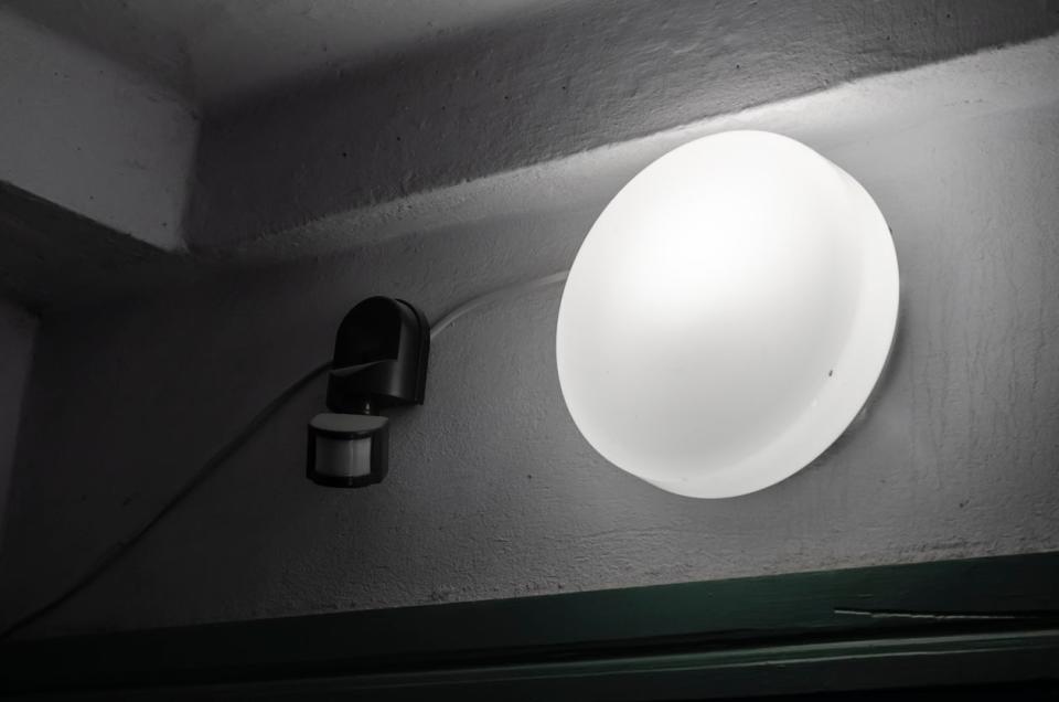 A close up of a motion sensor light at night. 