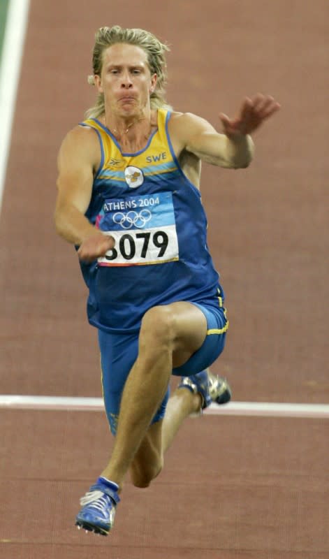 FILE PHOTO: Christian Olsson of Sweden competes in triple jump at Athens 2004 Olympic Games.