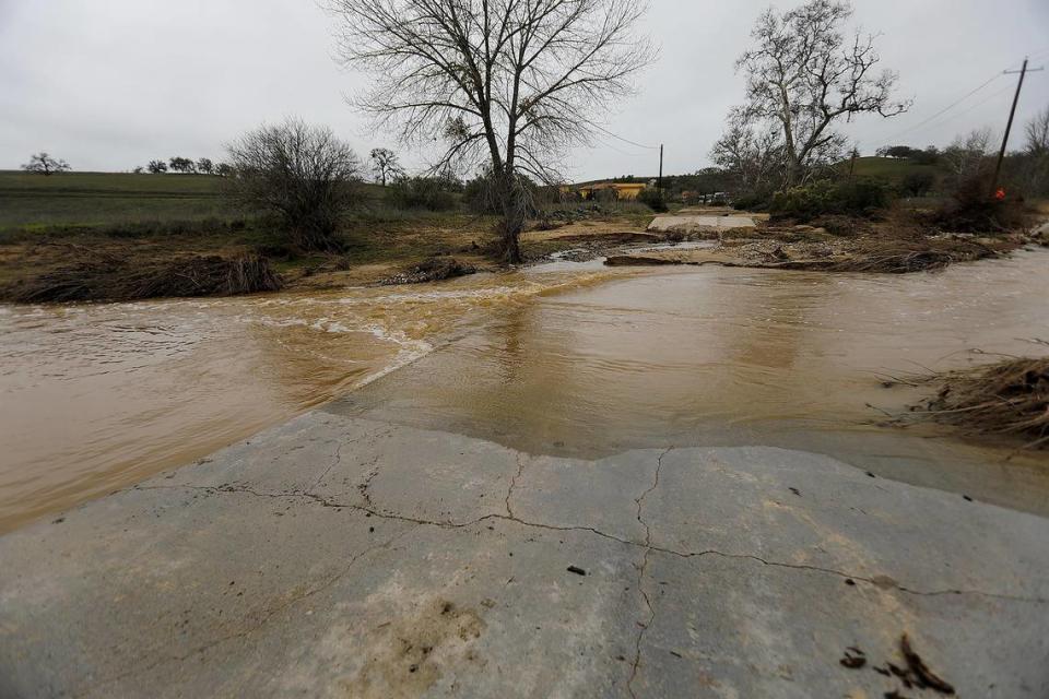 Floodwaters flow across San Marcos Creek Road on Jan. 11, 2023, at the spot where 5-year-old Kyle Doan was swept away.