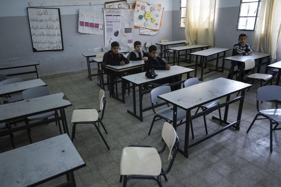 A handful of Palestinian schoolchildren attend a rare one-hour class taught by teachers who are not on strike, including substitute teachers and supporters of the Palestinian Authority, in a school in the West Bank city of Nablus, Tuesday, March. 28, 2023. Palestinian public schools across the occupied West Bank have been shuttered since Feb. 5, in one of the longest teachers' strikes in recent memory against the cash-strapped Palestinian Authority. (AP Photo/Majdi Mohammed)