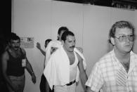 <p>The lead singer of Queen uses a towel to wipe off his sweat after a performance at London's Live Aid concert in 1985. The singer's boyfriend, Jim Hutton, is seen behind him. Mercury passed away in 1991 and left a portion of his fortune to his long-time boyfriend. </p>