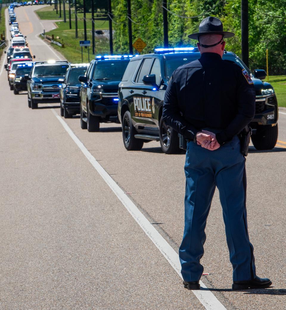 The procession makes its way to the cemetery during the funeral of Montgomery County Sheriff's Deputy Jermyius Young in Montgomery.