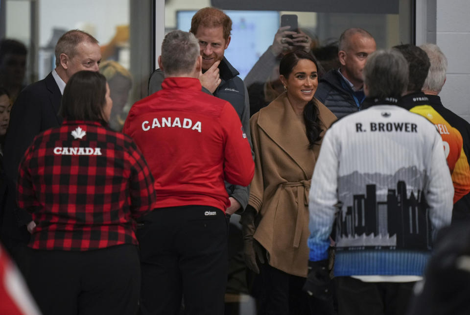 Prince Harry and Meghan Markle, the Duke and Duchess of Sussex, meet with wheelchair curling athletes during an Invictus Games training camp, in Vancouver, British Columbia, Friday, Feb. 16, 2024. (Darryl Dyck/The Canadian Press via AP)