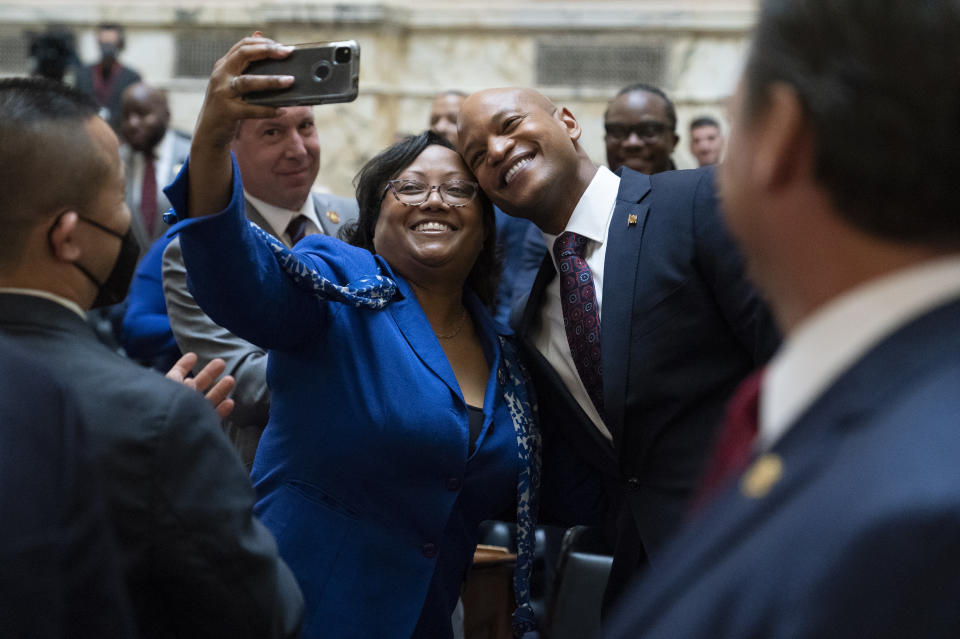 Maryland Gov. Wes Moore, center right, poses for a selfie with Delegate Sheree Sample-Hughes, D-Dorchester and Wicomico counties, while arriving to deliver his first state of the state address, two weeks after being sworn as governor, Wednesday, Feb. 1, 2023, in Annapolis, Md. (AP Photo/Julio Cortez)