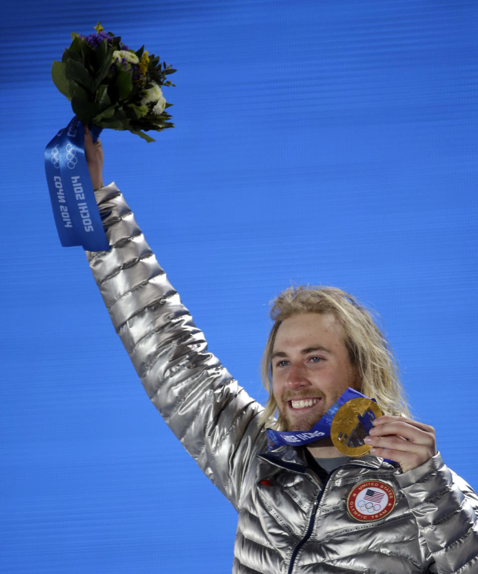 Gold medalist Sage Kotsenburg, of the United States, holds up his medal during the medal ceremony for the Snowboard Men's Slopestyle competition at the 2014 Winter Olympics, Saturday, Feb. 8, 2014, in Sochi, Russia. (AP Photo/David J. Phillip )