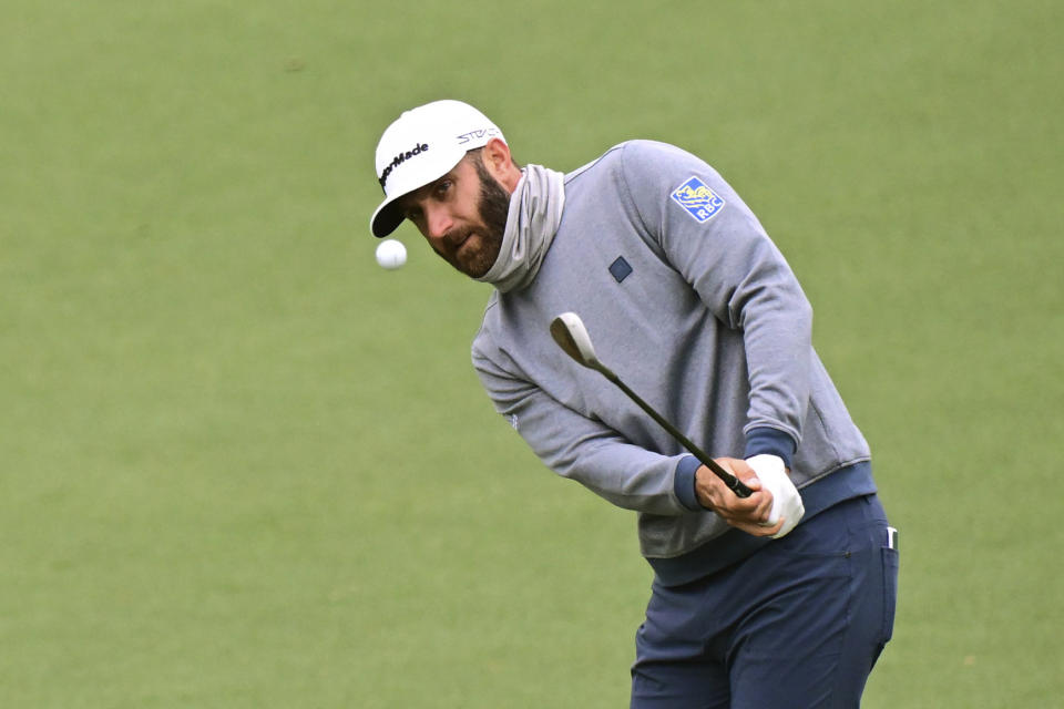 Dustin Johnson chips toward the second hole during the third round of the Masters at Augusta National Golf Club on Saturday, April 9, 2022, in Augusta, Ga. (Hyosub Shin/Atlanta Journal-Constitution via AP)