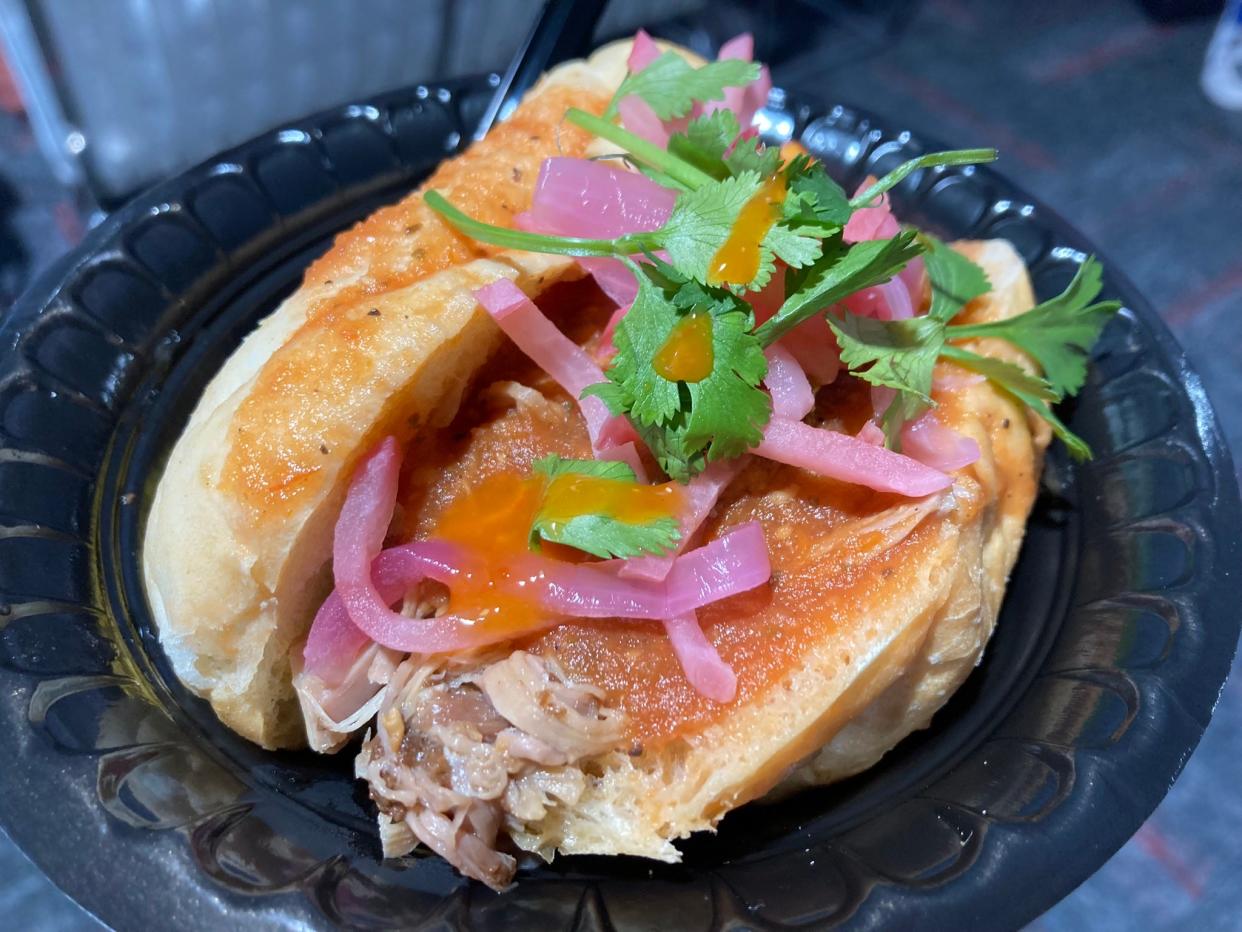 A torta ahogada with smoked carnita pork, pickled onions and cilantro atop sweet street corn prepared by chef Gabriel Rosado for Rev 2024 at the Indianapolis Motor Speedway on Saturday, May 4