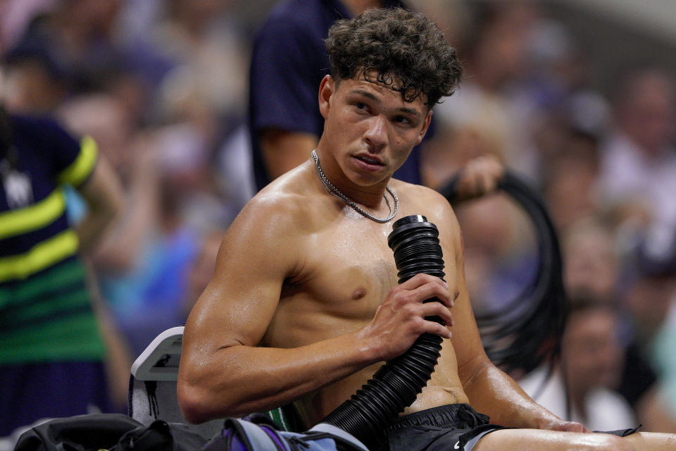 Ben Shelton, of the United States, blows cold air on his body during a break between games agaisnt Frances Tiafoe, of the United States, during the quarterfinals of the U.S. Open tennis championships, Tuesday, Sept. 5, 2023, in New York. (AP Photo/Eduardo Munoz Alvarez)