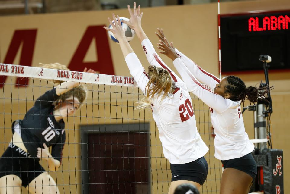 Alabama women's volleyball player Sarah Swanson (20) makes a block against Arkansas' Jillian Gillen (10). The Arkansas Razorbacks women's volleyball team defeated Alabama in four sets in Tuscaloosa, Alabama, on Sunday, Nov. 7, 2021.