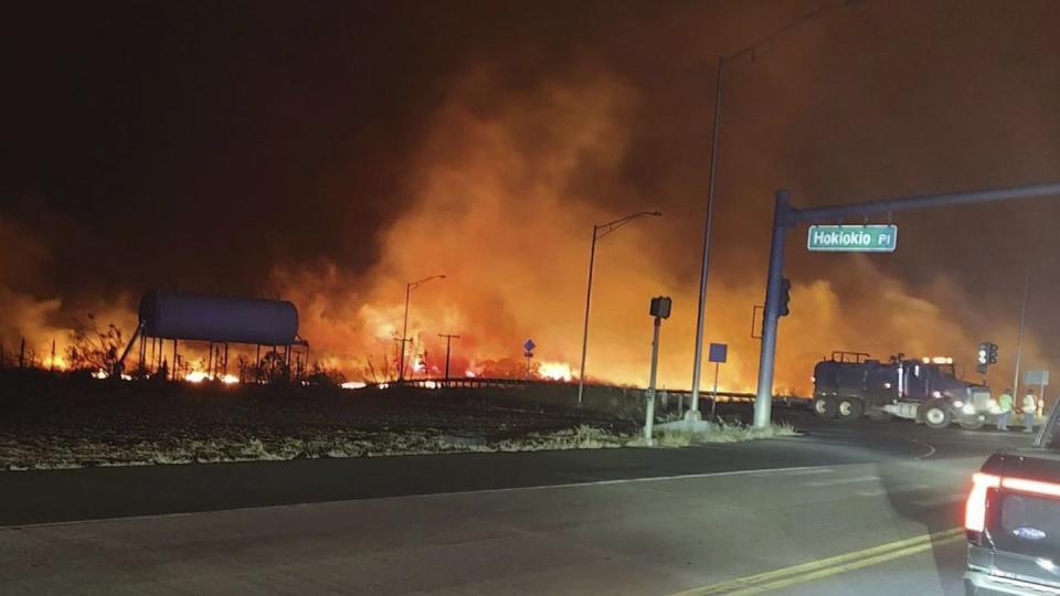 This photo provided by County of Maui shows fire and smoke filling the sky from wildfires on the intersection at Hokiokio Place and Lahaina Bypass in Maui, Hawaii on Tuesday, Aug. 8, 2023. (Zeke Kalua/County of Maui via AP)