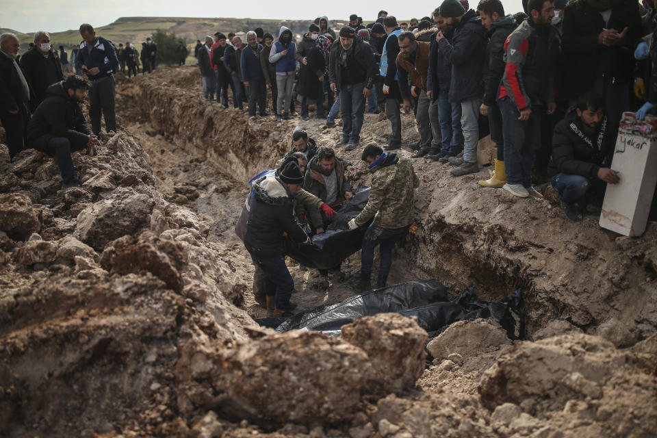 People bury their loved ones, victims of Monday earthquake, in Adiyaman, Turkey, Friday, Feb. 10, 2023. Emergency crews made a series of dramatic rescues in Turkey on Friday, pulling several people, some almost unscathed, from the rubble, four days after a catastrophic earthquake killed more than 20,000. (AP Photo/Emrah Gurel)