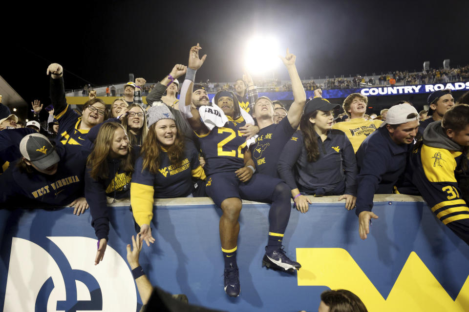 West Virginia's Jaheim White (22) celebrates in the student section after winning an NCAA college football game against BYU on Saturday, Nov. 4, 2023, in Morgantown, W.Va. West Virginia won 37-7. (AP Photo/Chris Jackson)