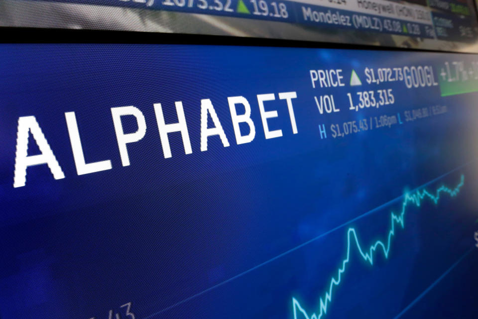 FILE- In this Feb. 14, 2018, file photo the logo for Alphabet appears on a screen at the Nasdaq MarketSite in New York. Google parent Alphabet Inc. has rejected several shareholder proposals aimed at linked executive pay to diversity goals, being more open about its lobbying expenses, narrowing the gender pay gap, and weakening the grip founders Larry Page and Sergey Brin have on company voting stock. (AP Photo/Richard Drew, File)