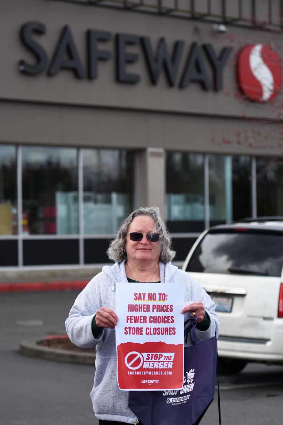 Port Orchard resident and Albertsons employee Sandy Pyle, 70, participates in a leaflet action to inform the public of the proposed merger between Kroger and Albertsons on April 5. Pyle has worked in the customer service department at Albertsons for almost 20 years.