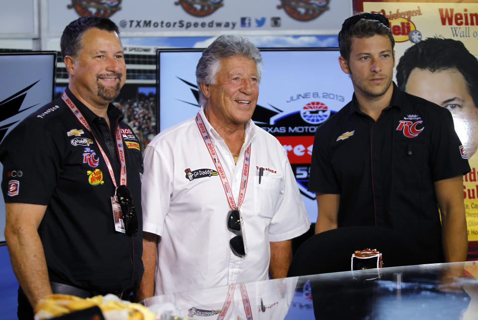 FILE - In this June 7, 2013, photo, Michael Andretti, left, his father, Mario, center, and son, Marco, right, pose for a group photo following a news conference at Texas Motor Speedway in Fort Worth, Texas. Marco Andretti made the decision at the start of this year to step away from full-time racing and essentially end three generations of the most famous family in motorsports competing at the highest level. (AP Photo/Tim Sharp, File)