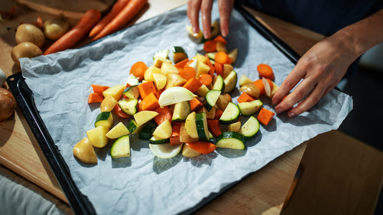 putting chopped veggies in roasting pan