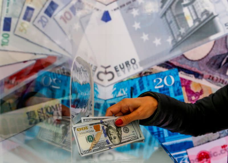 FILE PHOTO: FILE PHOTO: A money changer sells U.S. dollar bills in Ankara