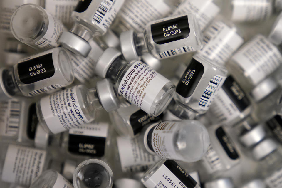 FILE - In this Friday, Jan. 22, 2021, file photo, empty vials of the Pfizer-BioNTech COVID-19 vaccine are seen at a vaccination center at the University of Nevada, Las Vegas. COVID-19 vaccine makers tell Congress to expect a big jump in the delivery of doses over the coming month. The companies insisted Tuesday, Feb. 23, at a hearing that they will be able to provide enough vaccine for most Americans by summer. (AP Photo/John Locher, File)