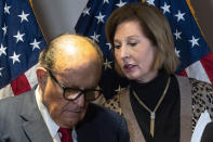 FILE - Former Mayor of New York Rudy Giuliani, left, listens to Sidney Powell, both lawyers for President Donald Trump, during a news conference at the Republican National Committee headquarters, Nov. 19, 2020, in Washington. The House committee investigating the Capitol insurrection has issued subpoenas to some of Donald Trump's closest advisers, including Rudy Giuliani. (AP Photo/Jacquelyn Martin, File)